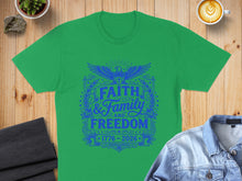 Load image into Gallery viewer, Green t-shirt with blue "Faith and Family Freedom 1776-2026" graphic.
