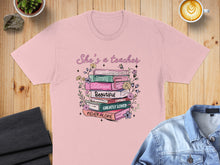 Load image into Gallery viewer, Pink t-shirt with a stack of books featuring inspirational quotes for teachers.

