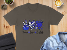 Load image into Gallery viewer, T-shirt with blue peace sign, heart, and dental graphics reading "Peace Love Dental".
