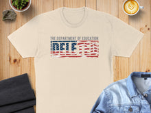 Load image into Gallery viewer, Cream t-shirt with "DELETED" text in red, white, and blue stripes.
