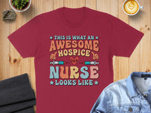 Load image into Gallery viewer, Maroon t-shirt with "This is what an awesome hospice nurse looks like" text.
