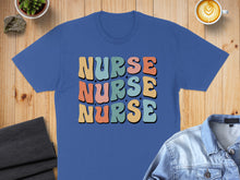 Load image into Gallery viewer, Blue t-shirt with "NURSE" in colorful, wavy letters.

