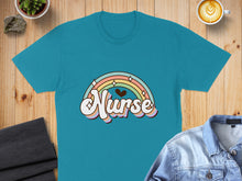 Load image into Gallery viewer, Teal t-shirt with "Nurse" text and a pastel rainbow graphic.
