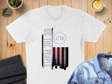 Load image into Gallery viewer, White t-shirt with distressed American flag and "WE THE PEOPLE" text.

