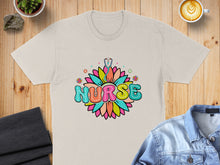 Load image into Gallery viewer, Cream t-shirt with colorful "NURSE" text in a flower design.
