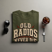 Load image into Gallery viewer, Green t-shirt with "OLD RADIOS NEVER DIE" text, sunglasses, and a watch.
