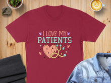 Load image into Gallery viewer, Burgundy t-shirt with "I Love My Patients" text and heart, stethoscope design.
