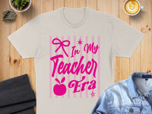 Load image into Gallery viewer, Beige t-shirt with pink "In My Teacher Era" text and bow graphic.
