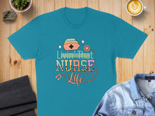 Load image into Gallery viewer, Teal t-shirt with "Livin' That Nurse Life" text and stethoscope graphic.

