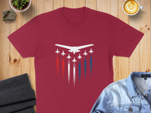 Load image into Gallery viewer, Maroon t-shirt with a formation of white jets trailing red, white, and blue smoke.
