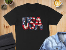 Load image into Gallery viewer, Black t-shirt with "USA" text in patriotic stars and stripes pattern.
