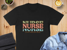 Load image into Gallery viewer, Black t-shirt with "NURSE" in large colorful letters and "LOVE INSPIRE HEAL".
