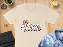 Load image into Gallery viewer, Cream t-shirt with "Blessed Nurse" text and colorful pastel accents.
