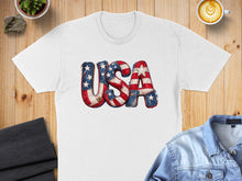 Load image into Gallery viewer, White t-shirt with distressed "USA" text featuring American flag pattern.
