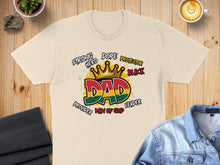 Load image into Gallery viewer, Cream t-shirt with "DAD" in crown and flag, surrounded by "Strong Hero Protector Black" and "Provider Man of God".
