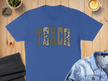 Load image into Gallery viewer, Blue t-shirt with "TEACH" in camouflage print across the chest.
