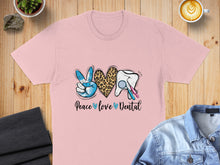 Load image into Gallery viewer, Pink t-shirt with "Peace love Dental" graphic featuring a peace sign, leopard print heart, and dental tools.
