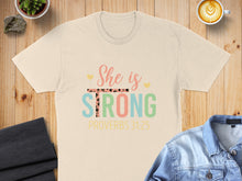 Load image into Gallery viewer, Light beige t-shirt with "She is Strong Proverbs 31:25" text.

