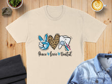 Load image into Gallery viewer, T-shirt with peace sign, leopard print heart, tooth, and dental tools, text "Peace love Dental".
