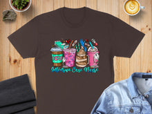 Load image into Gallery viewer, Brown t-shirt with colorful graphic of coffee cups and medical icons, "Intensive Care Nurse" text.
