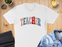 Load image into Gallery viewer, White t-shirt with "TEACHER" spelled out in colorful, patterned alphabet letters.
