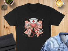 Load image into Gallery viewer, Black t-shirt with nurse-themed bow featuring stethoscope, heart, and "XOXO" pattern.

