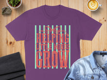 Load image into Gallery viewer, Purple t-shirt with "Helping Little Minds Grow" text in distressed font.
