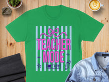 Load image into Gallery viewer, Green t-shirt with "TEACHER MODE" text, pink bow, and pencil graphic.
