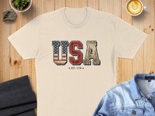 Load image into Gallery viewer, USA Est. 1776 graphic on a light-colored t-shirt.

