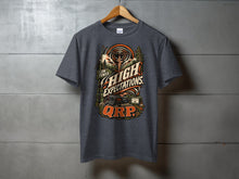 Load image into Gallery viewer, Dark gray t-shirt with "Low Power, High Expectations, QRP" graphic and radio equipment.
