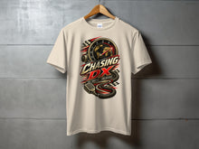 Load image into Gallery viewer, Light beige t-shirt with "Chasing DX" graphic featuring a globe, speedometer, and microphone.
