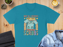 Load image into Gallery viewer, Teal t-shirt with "Not All Heroes Wear Capes Some Wear Scrubs" text and stethoscope.
