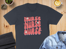 Load image into Gallery viewer, Dark gray t-shirt with "NURSE NURSE NURSE" in pink wavy text and white flowers.
