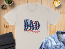Load image into Gallery viewer, Tan t-shirt with "Dad: The Man, The Myth, The Legend" text and American flag graphic.
