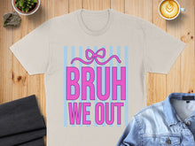 Load image into Gallery viewer, Beige t-shirt with pink text "BRUH WE OUT" on blue striped background.
