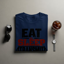 Load image into Gallery viewer, Navy t-shirt with "EAT SLEEP TRANSMIT" text, sunglasses, watch, and iced drink.
