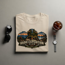 Load image into Gallery viewer, Cream t-shirt with "Radio Expedition Club" text and camping illustration.
