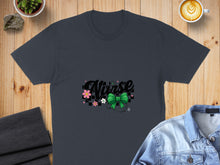Load image into Gallery viewer, Dark grey t-shirt with "Nurse" text, green bow, and stethoscope graphic.
