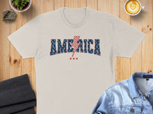 Load image into Gallery viewer, Cream t-shirt with "AMERICA" and a red lightning bolt graphic.
