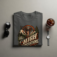 Load image into Gallery viewer, Grey t-shirt with "Low Power. High Expectations." graphic of mountains and radio waves.
