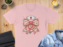 Load image into Gallery viewer, Pink t-shirt with a stethoscope, medical symbols, and "XOXO" ribbon graphic.

