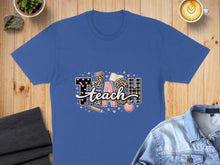 Load image into Gallery viewer, Blue t-shirt with "TEACH" design featuring apples, books, and leopard print.
